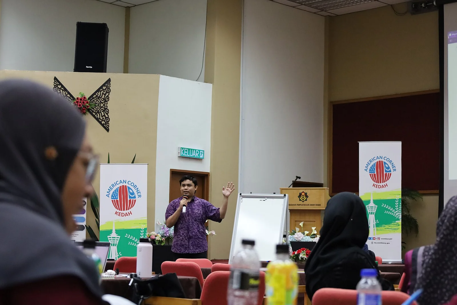 Participants listening to a workshop presentation in Malaysia